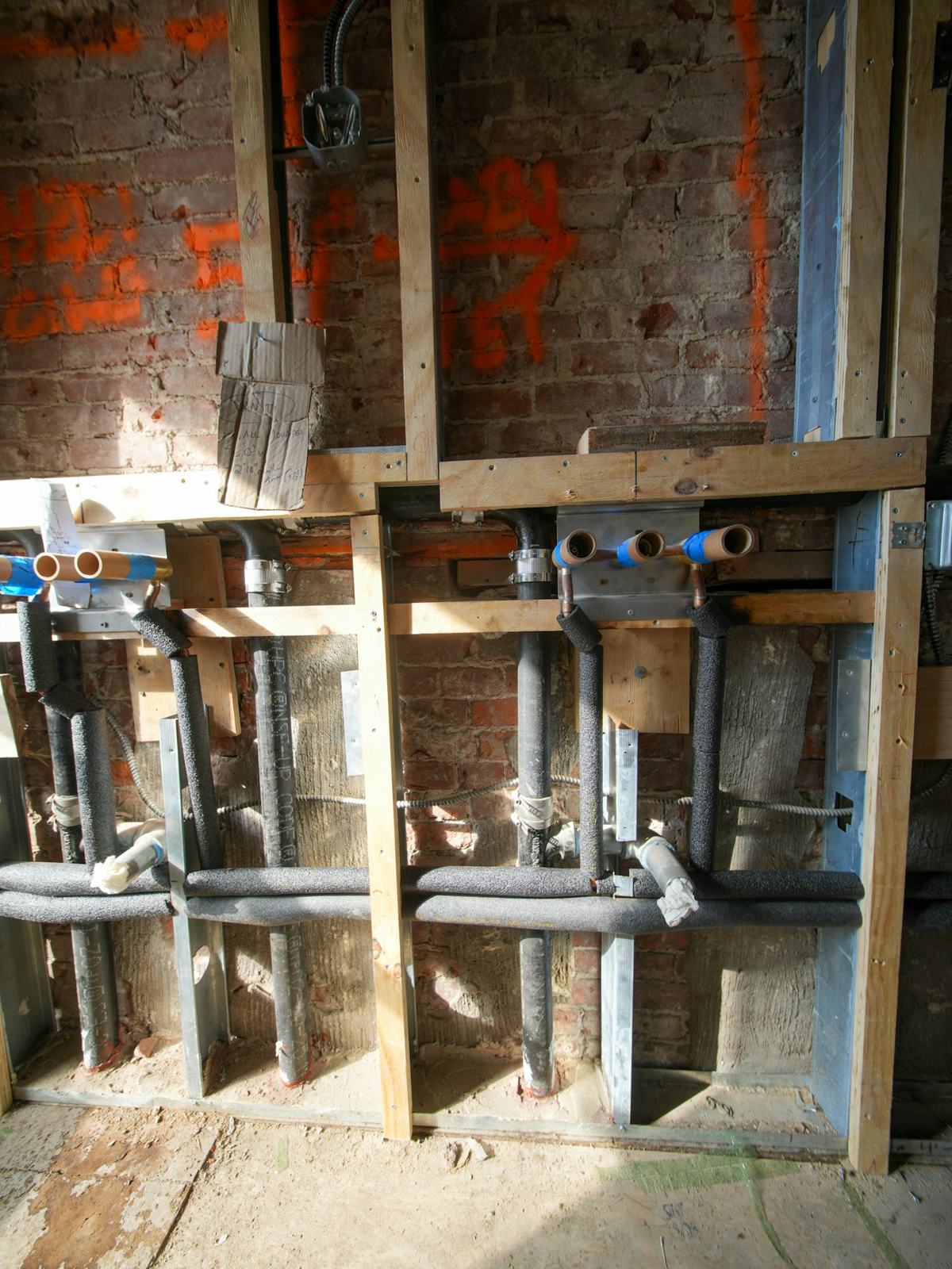 Plumbing rough-in inside a framed wall